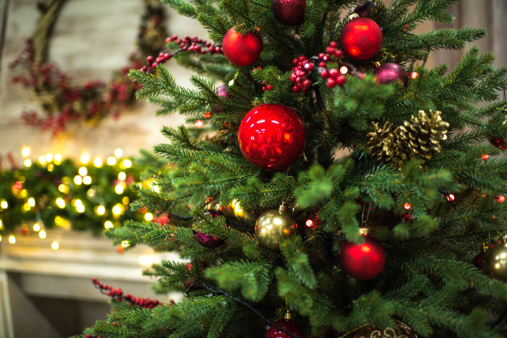 close up of artificial Christmas tree with red ornaments