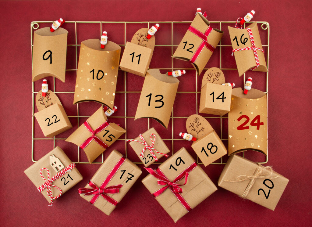Advent calendar with craft carton boxes on the mesh board. Christmas celebration, xmas gifts,