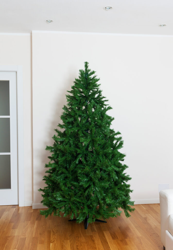 Artificial Christmas tree in front of white wall
