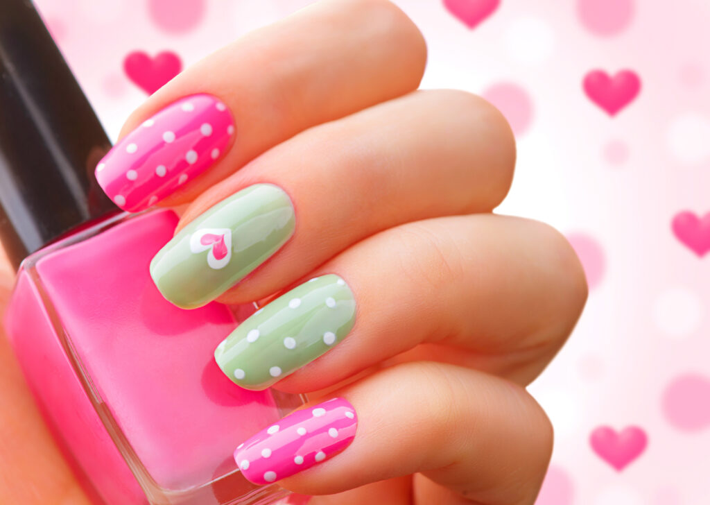 fingernails with pink polish and polka dots