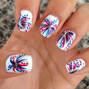 nails with white polish and firework designs